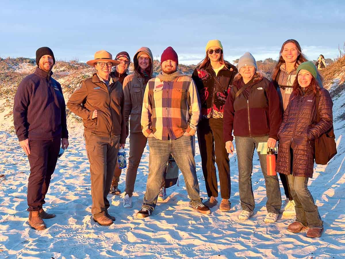 Nine Surfrider volunteers standing on Asilomar beach looking into the sunset during Surfrider's regional conference in Monterey, ca Photo: Harry Parker Photography