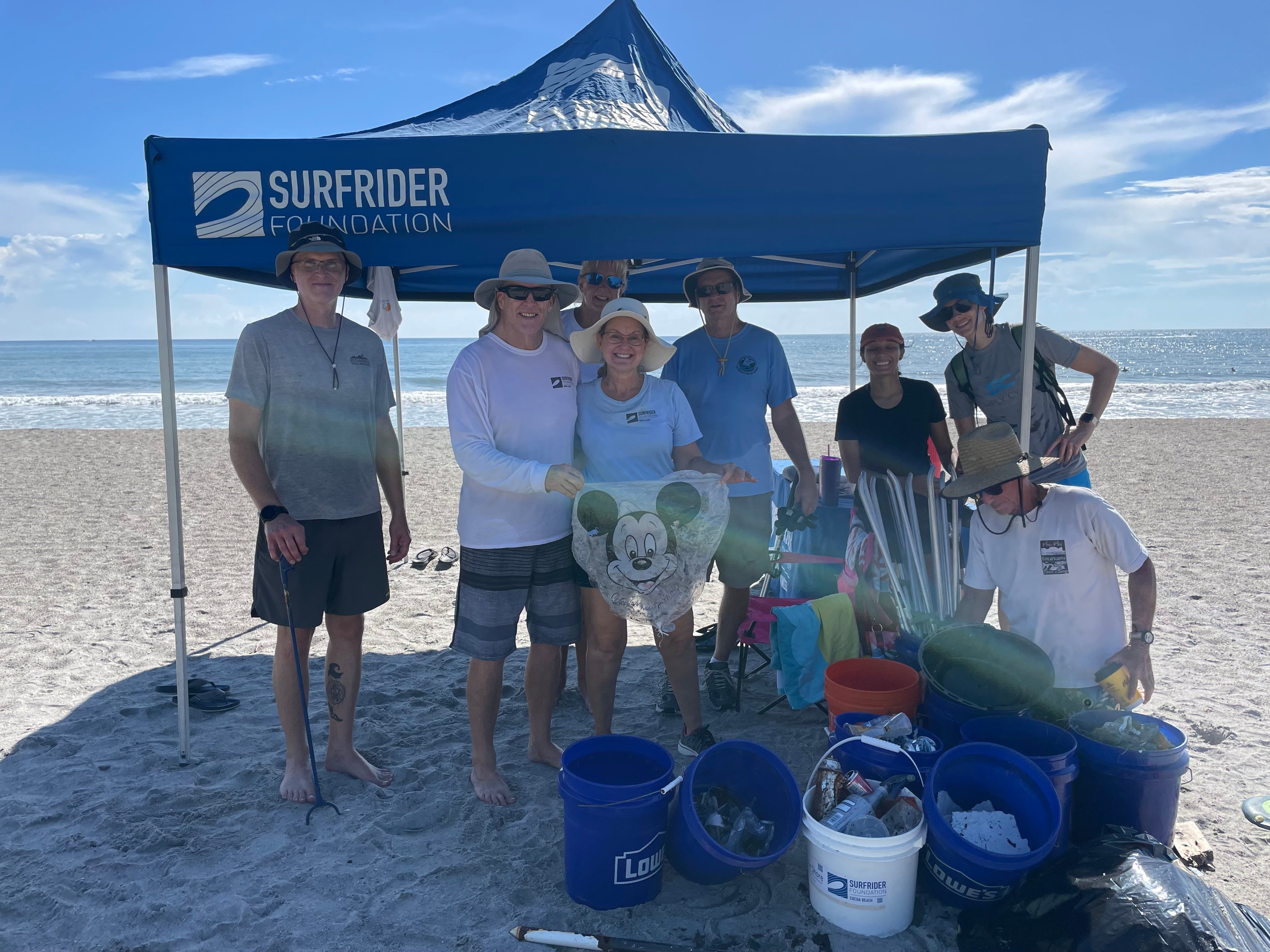 Smiling under a tent beach clean up