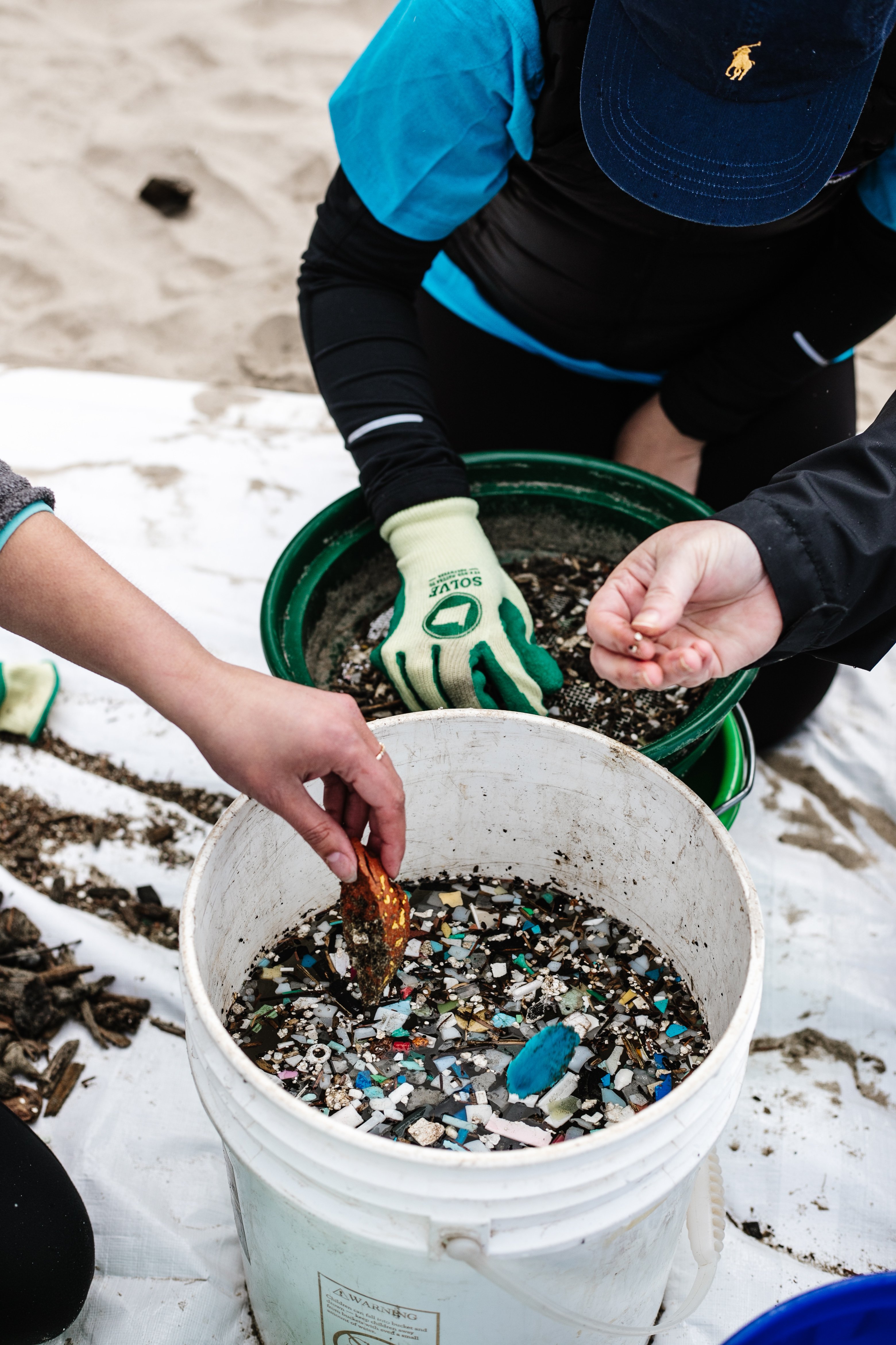 Volunteers sorting trash from a beach cleanup 
