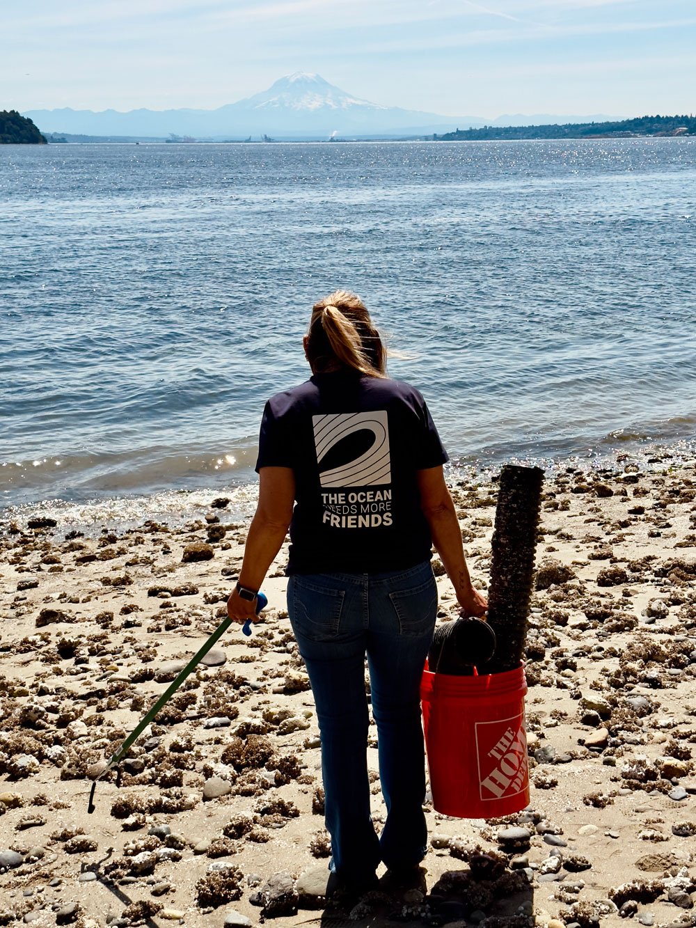 Kelly Jones With the Surfrider South Sound Chapter picking up trash on a beach