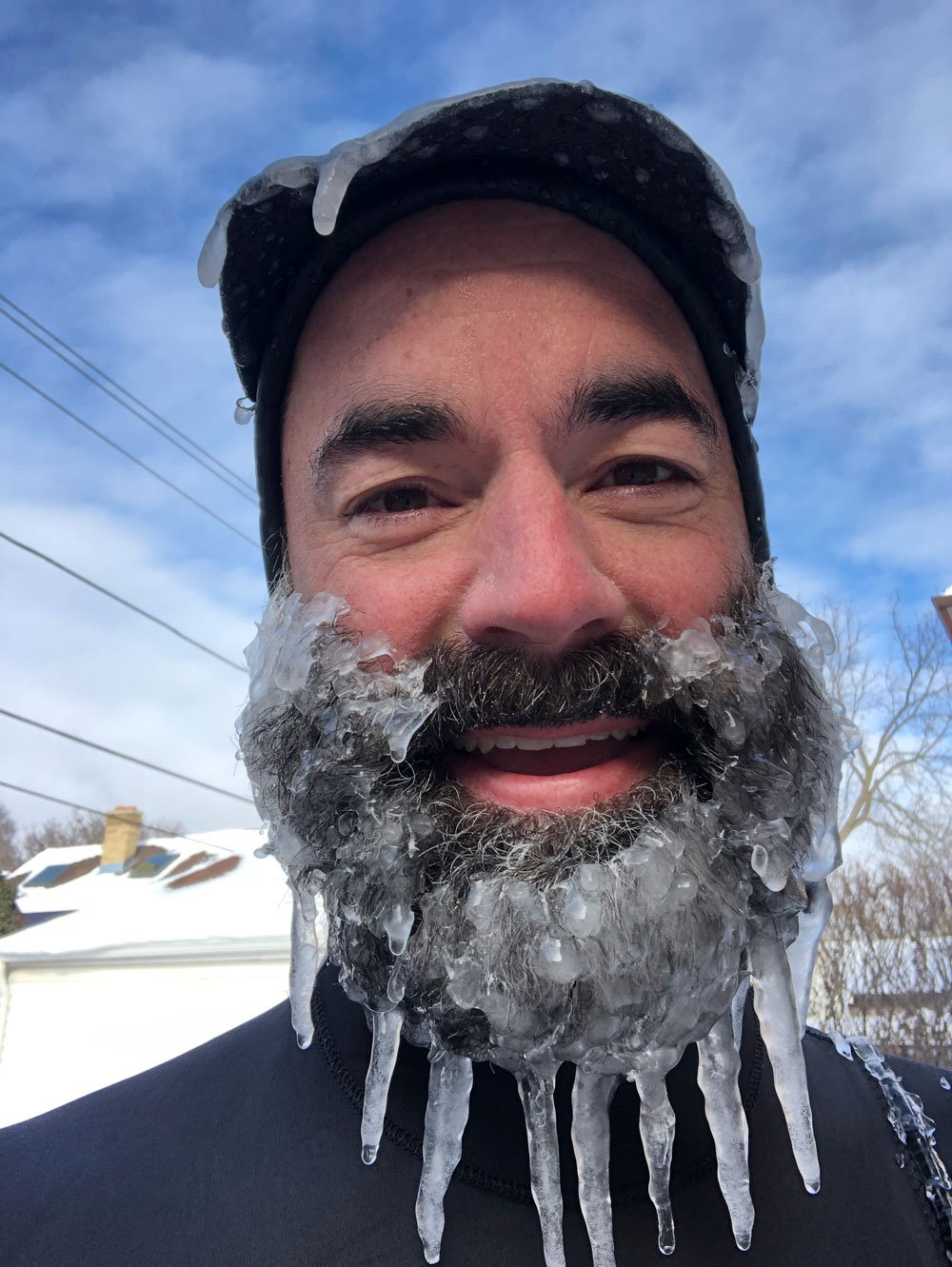 Nicholas Hade with the Milwaukee Chapter with icicles in his beard after surfing