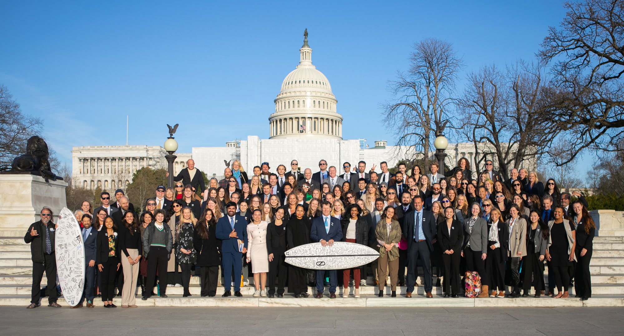 A large group of volunteers posing in front of the US Capitol building in DC 