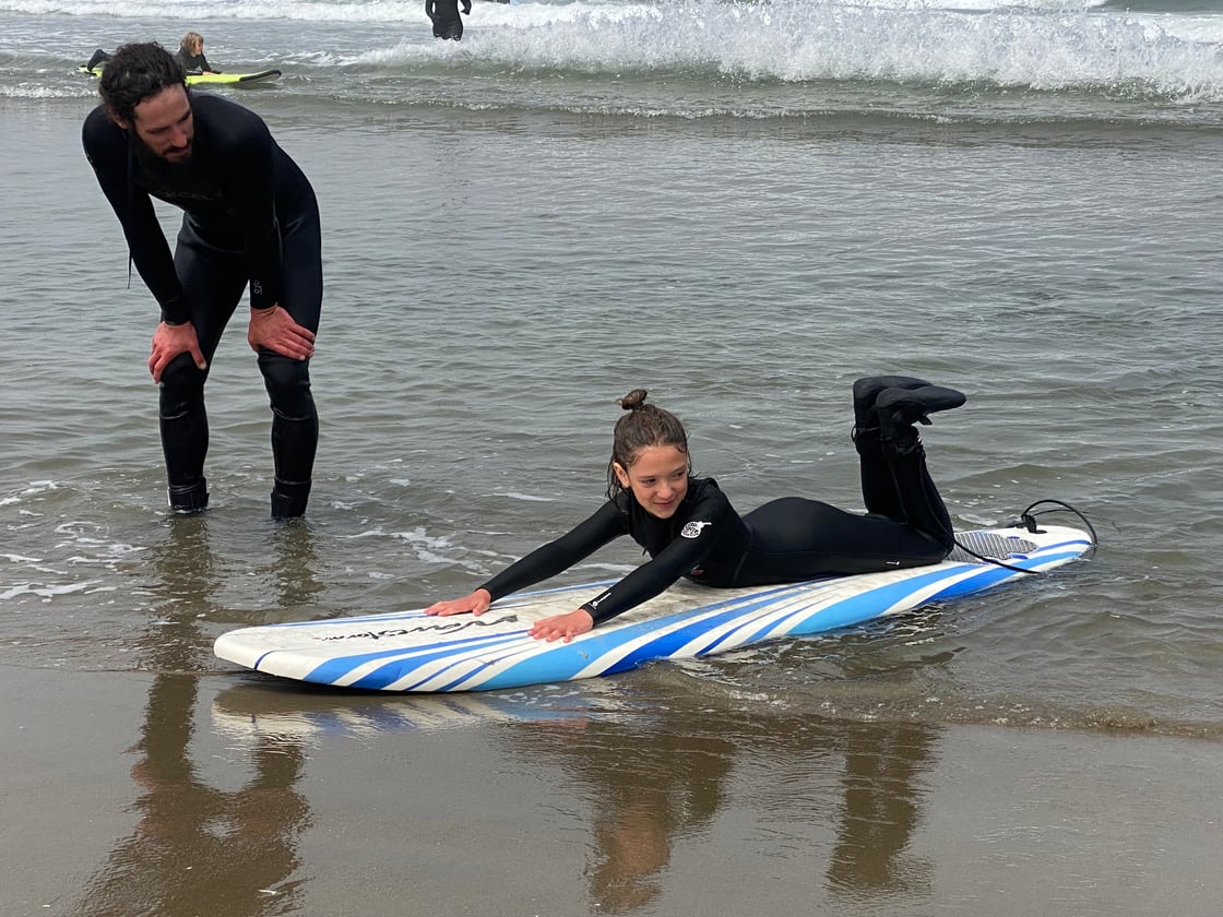 Child on a surfboard at the Coos Bay surf camp