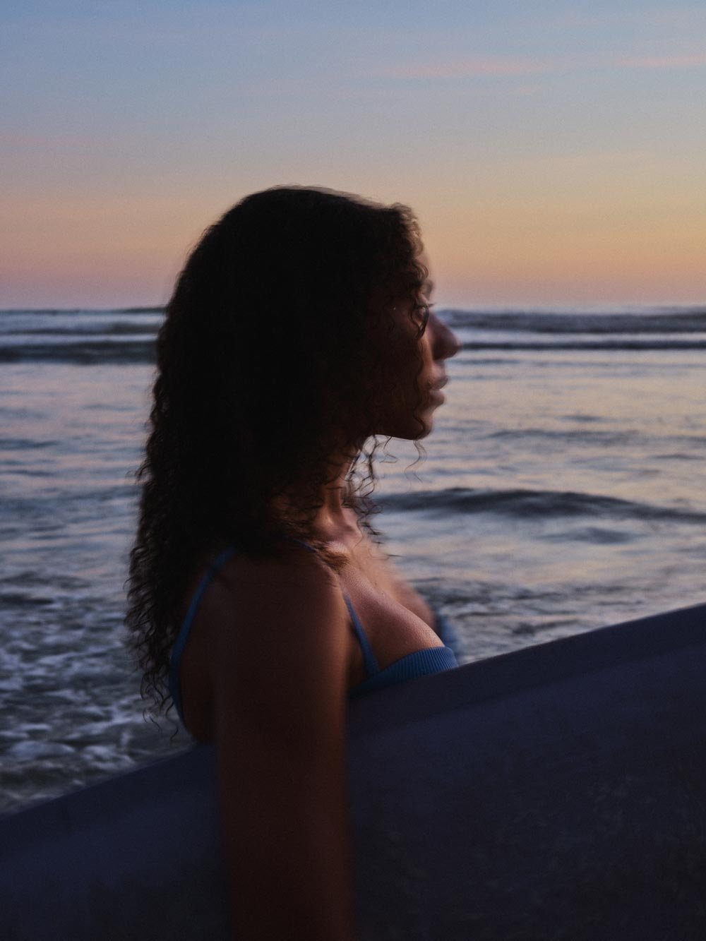 Photo of Gabriella Angotti-Jones on the beach at sunset.
