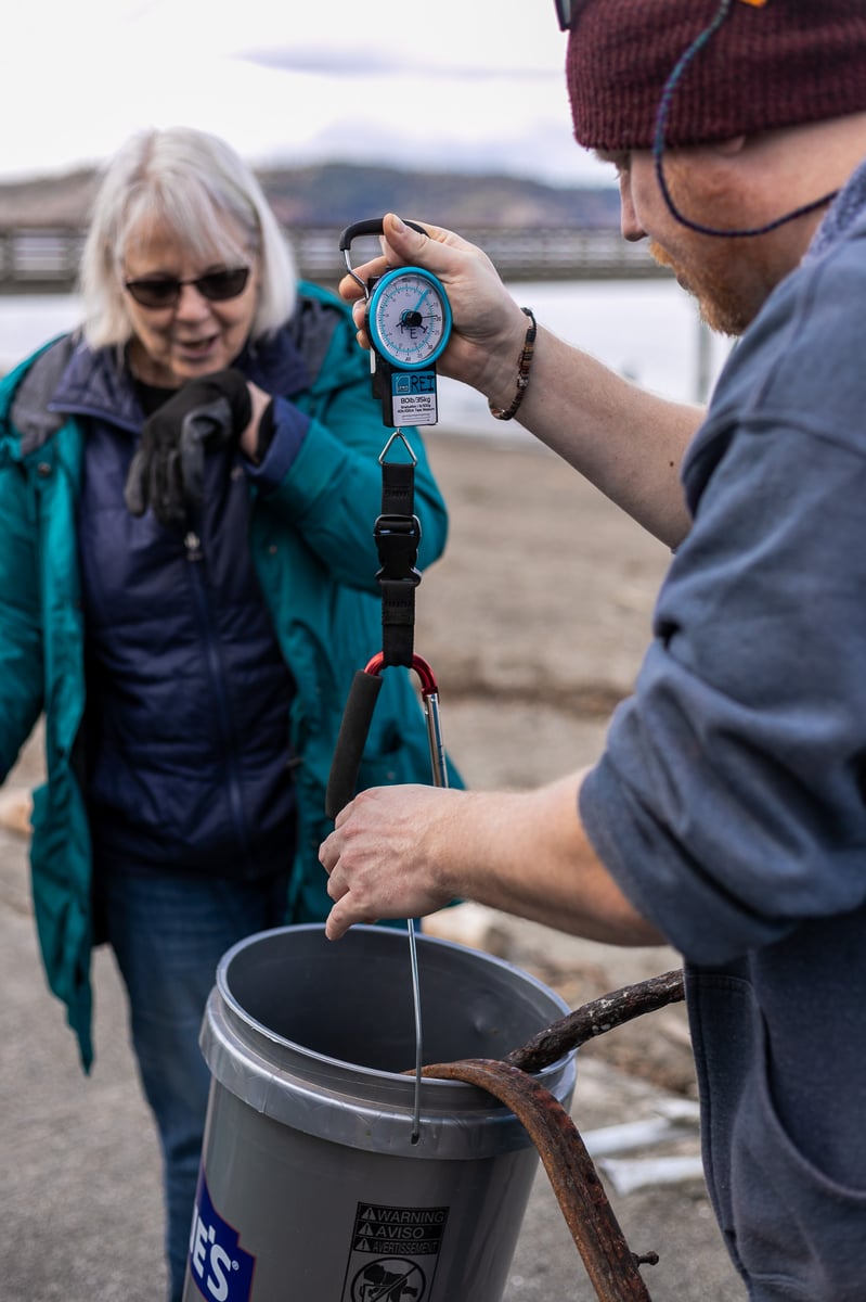  A senior-aged female volunteer getting her beach cleanup trash weighed