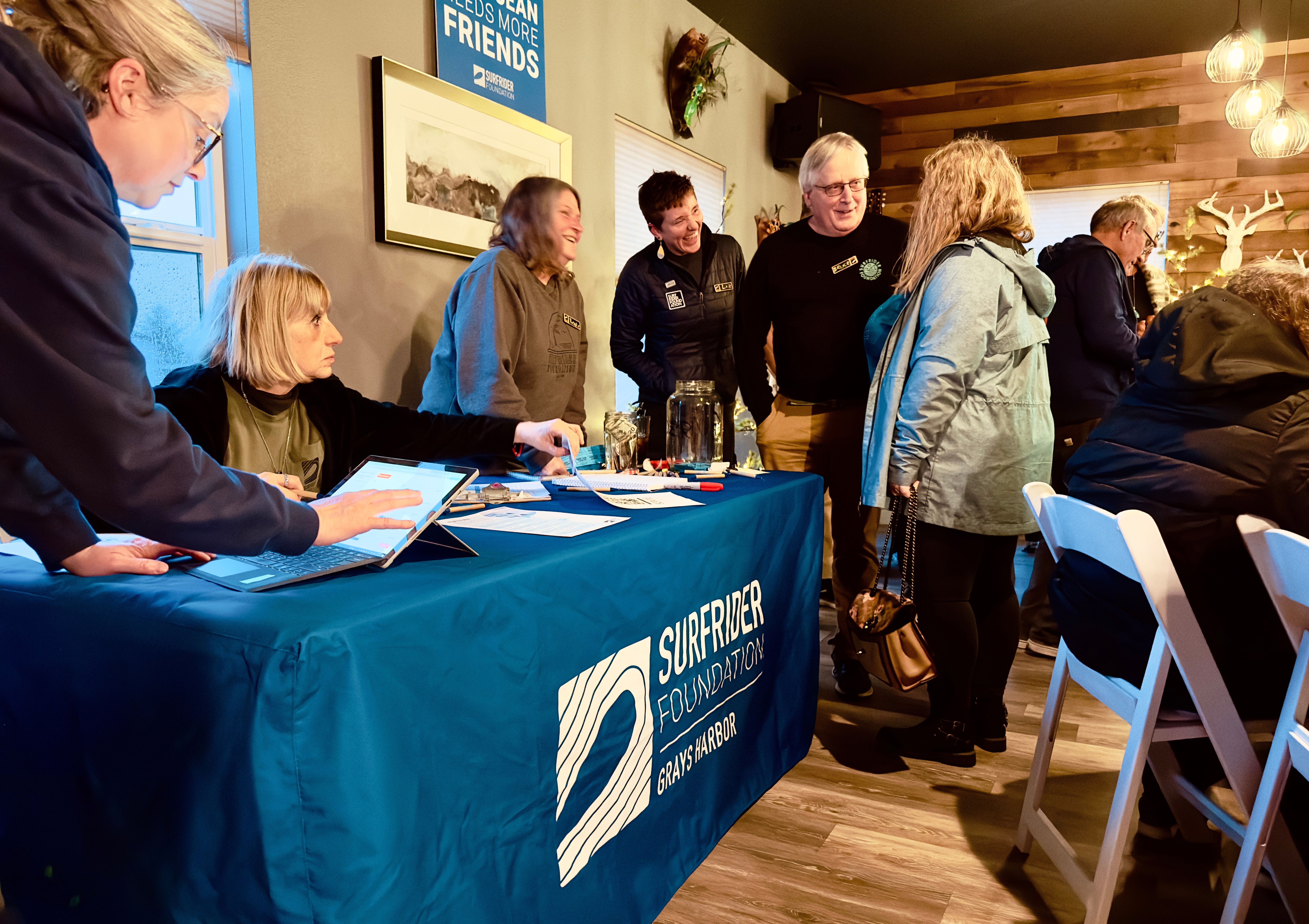 Surfrider Grays Harbor table and volunteers at their launch party