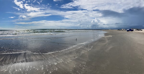 Beach shoreline with thunderclouds in the background