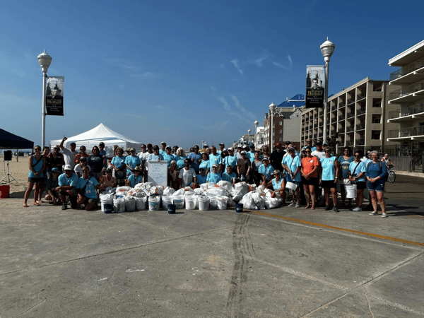 Group image of volunteers at the OC Community Beach Cleanup in July 