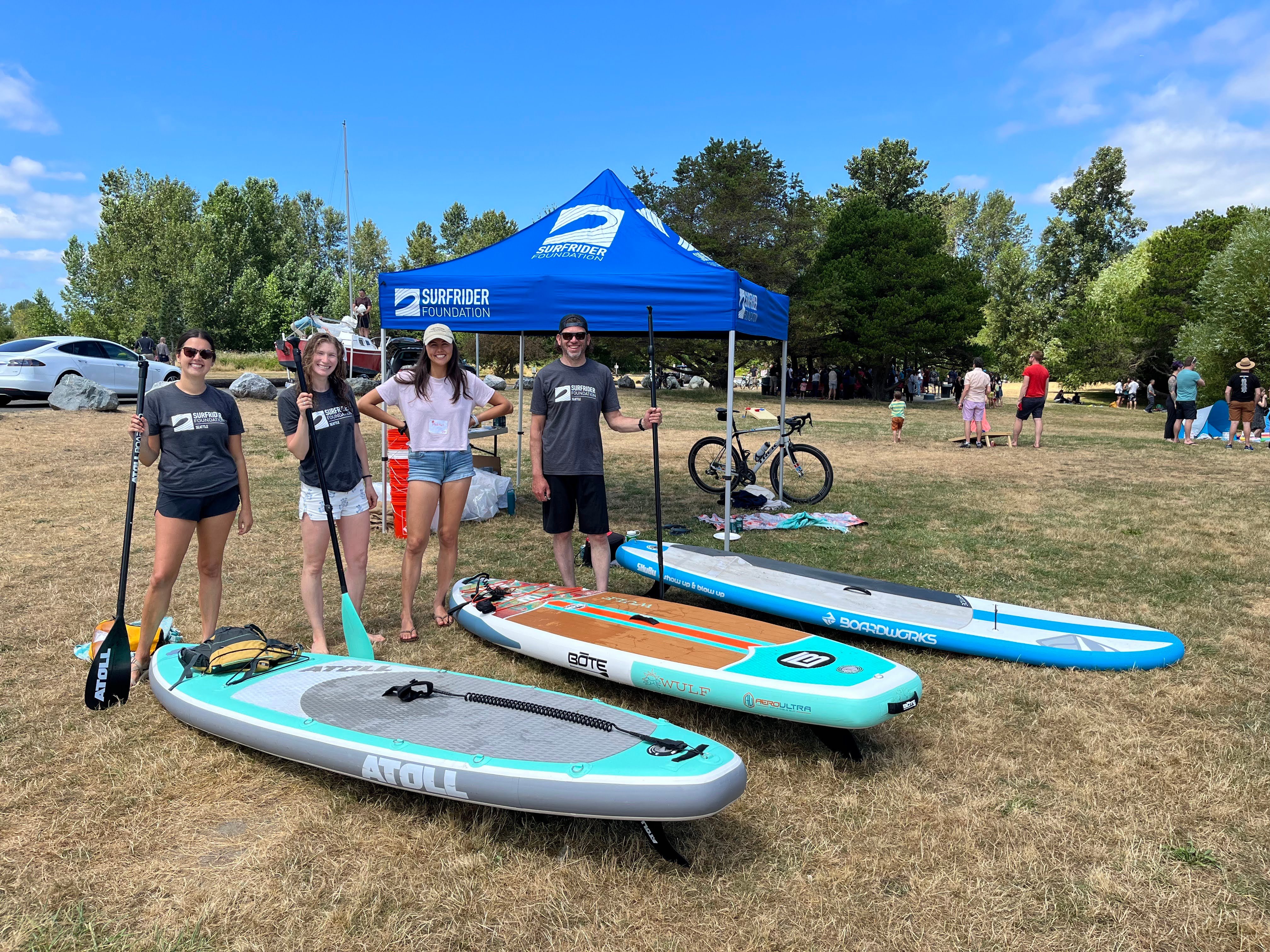 Surfrider members at a Clean and Cruise event with their paddle boards.