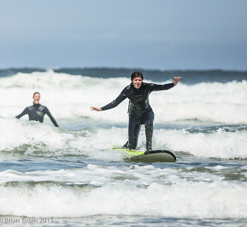Paige catching a wave at the Surfider x Warm Current surf camp