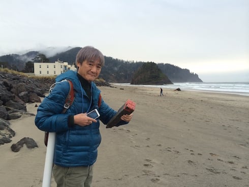 Dr. Isobe holds a Japanese property marker, found near one of the potential study sites