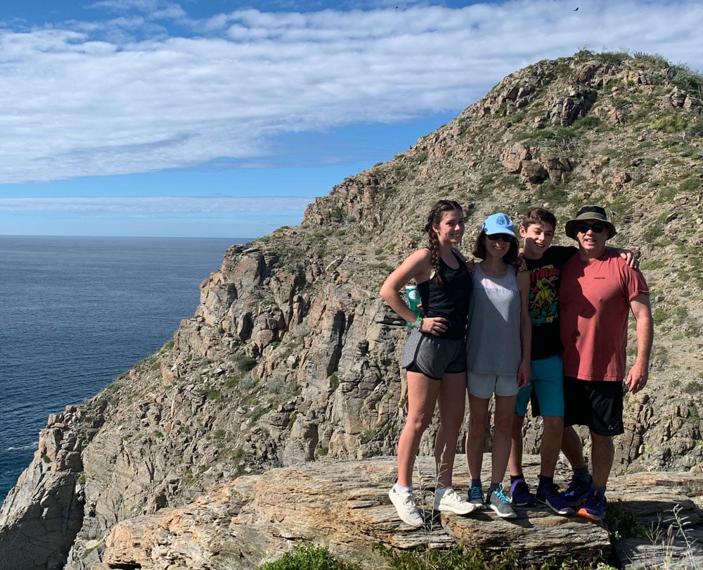 John Kollmorgen and his family with the ocean behind them