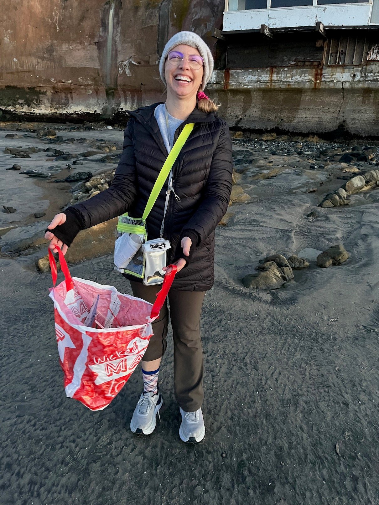 A volunteer holding her bag of collected trash