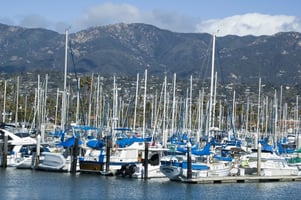 Many yachts in marina, city and mountains beyond, Santa Barbara, California
