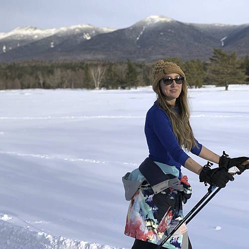 Christine Cross Country Skiing in front of mountains
