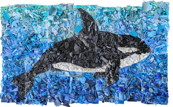 a mural of an orca made out of marine debris