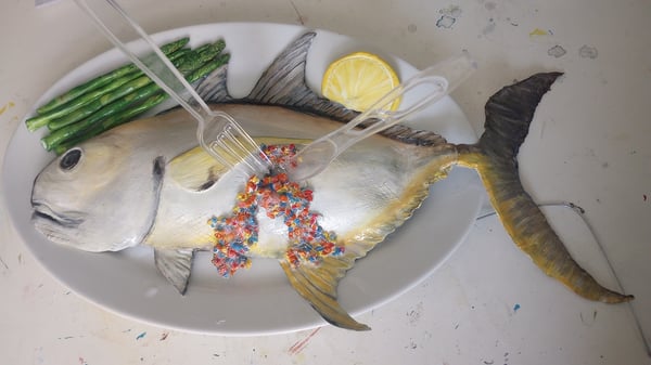 Art: Microplastics in Food. Plastics in a fish