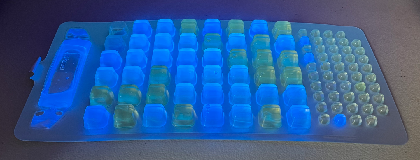 This Quanti-Tray shows wells containing a water sample mixed with a special reagent. The blue fluorescence under UV light indicates the presence and concentration of enterococcus bacteria. Photo credit: BWTF