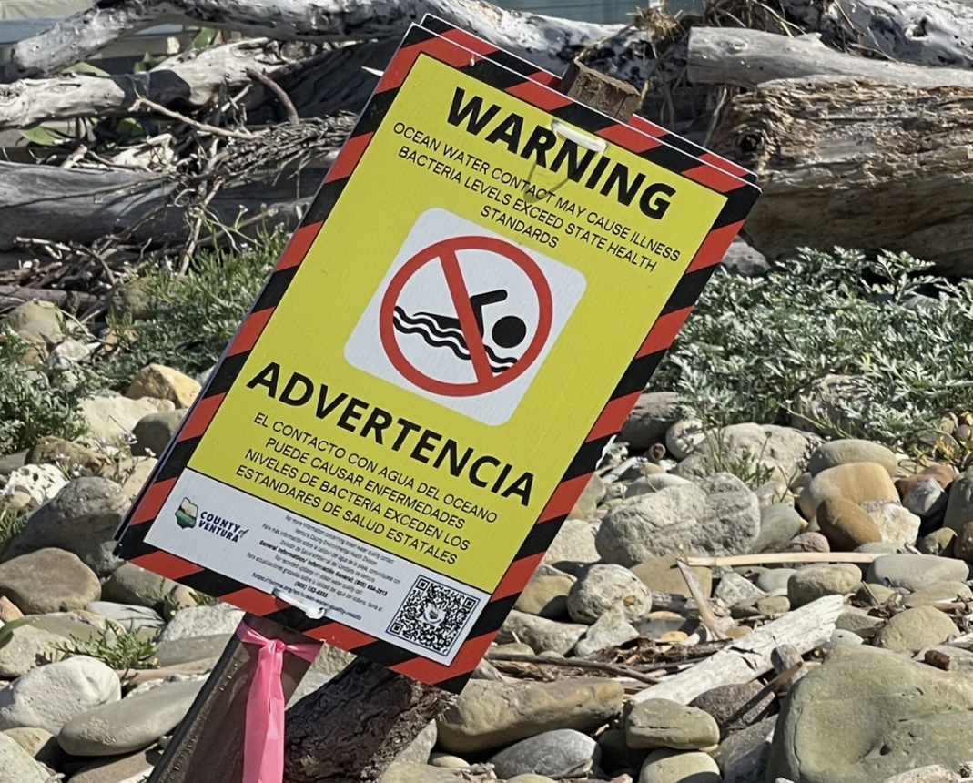 A sign posted at Rincon Point in Ventura County, CA warning people that the ocean water may cause illness because bacteria levels exceed state health standards.