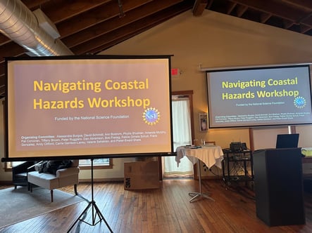 Two screens displaying the conference title slide "Navigating Coastal Hazards Workshop"