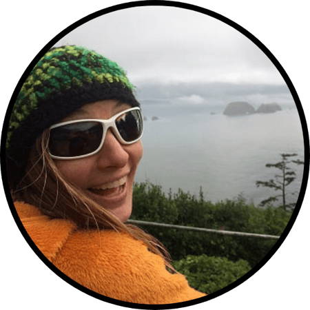 Headshot of Liz overlooking a misty day on the coast