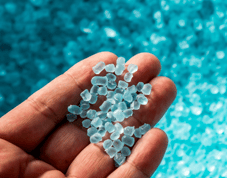 A handful of tiny bright blue nurdles, or plastic pellets