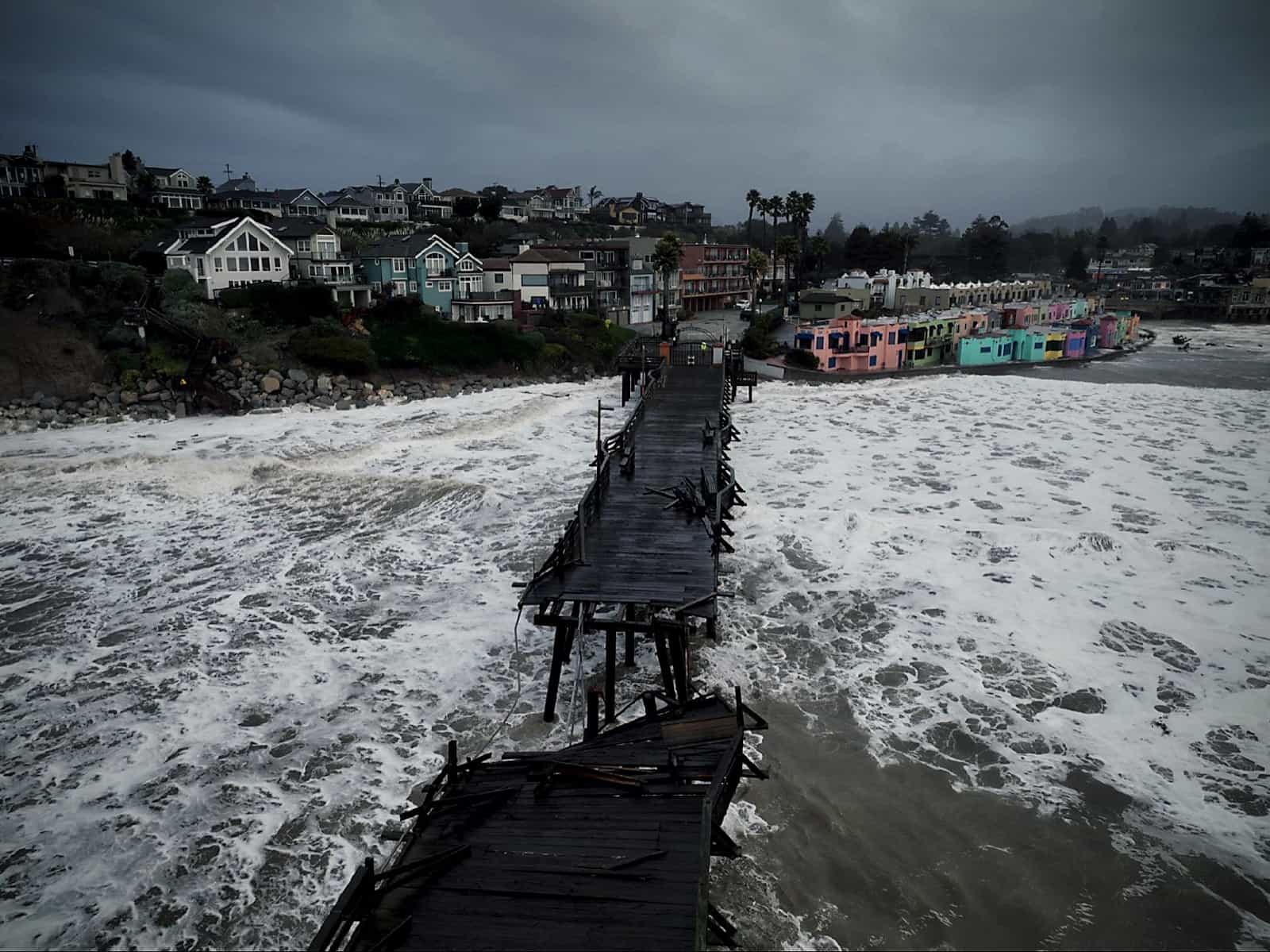 A section of the Santa Cruz boardwalk collapses under the raging storm tides.