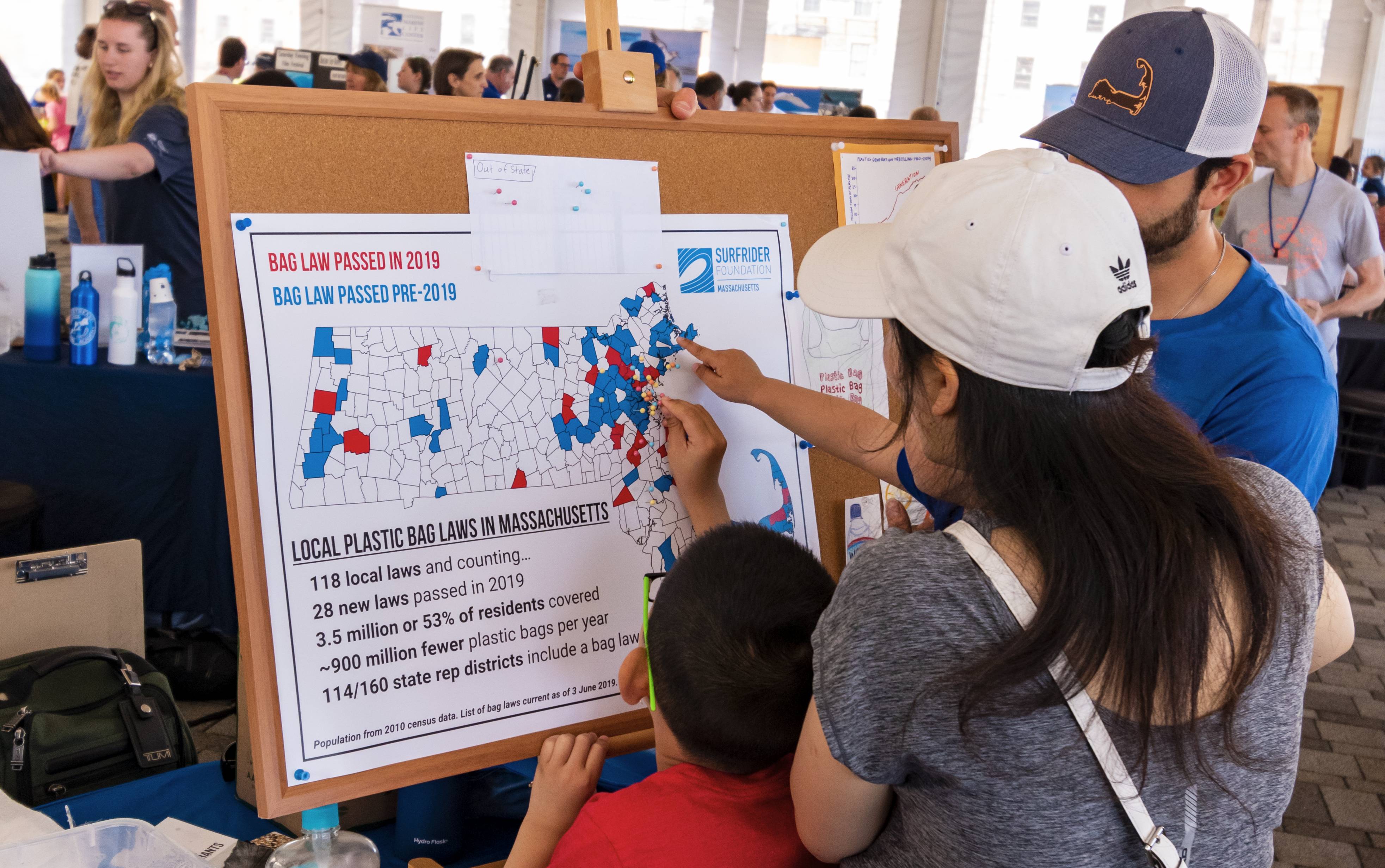 Child Interacts with Map of Massachusetts Showing Local Bag Laws