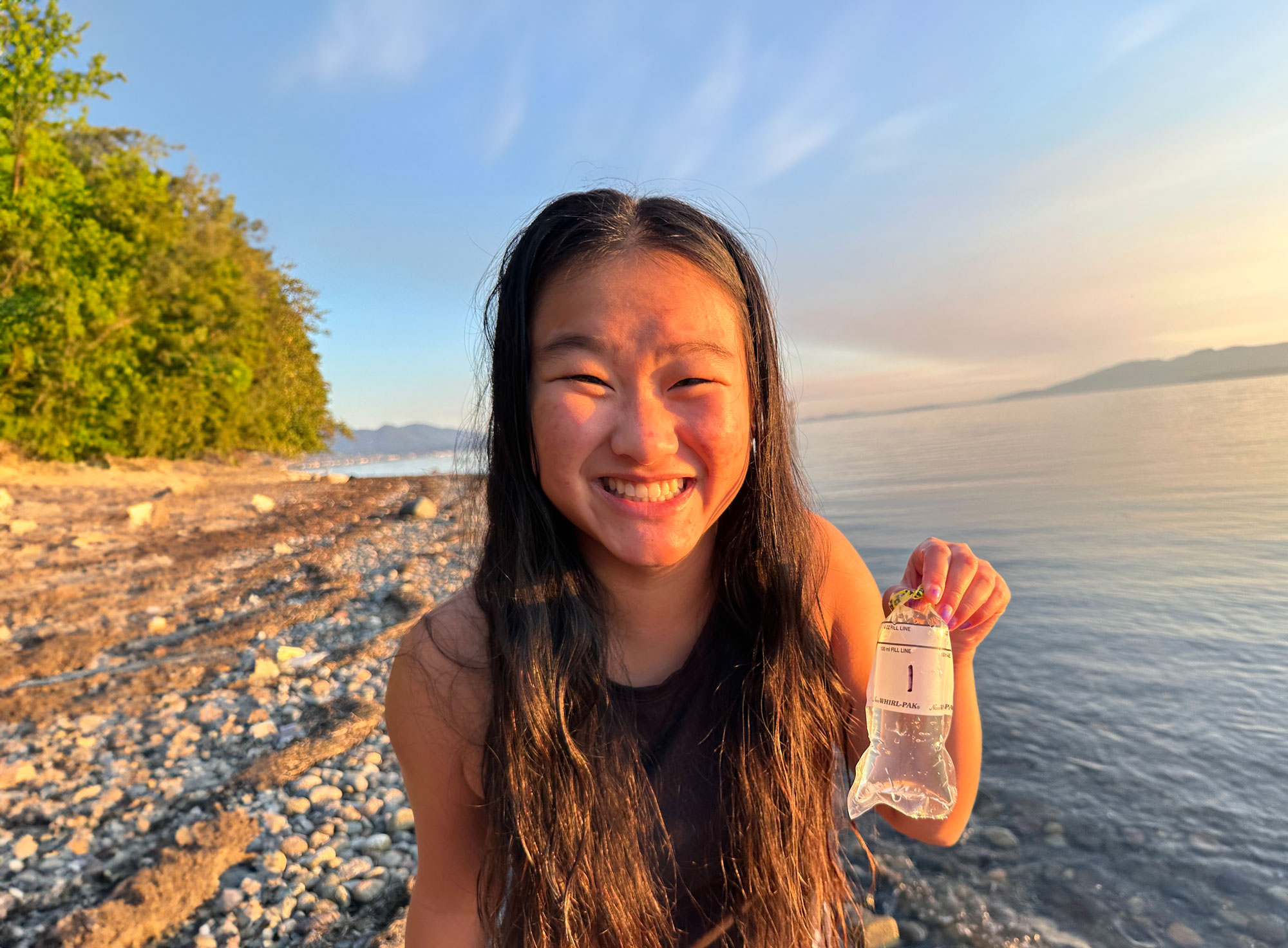Grace Schamber With The Northwestern Straits Chapter holding a water quality samples