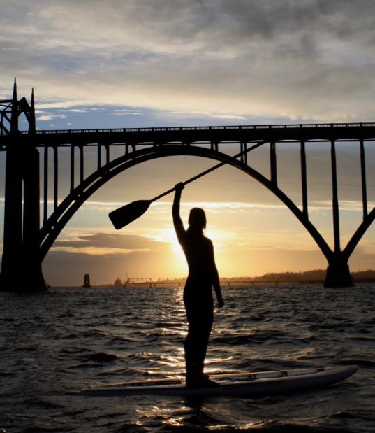 Sunset surf with a bridge in the background