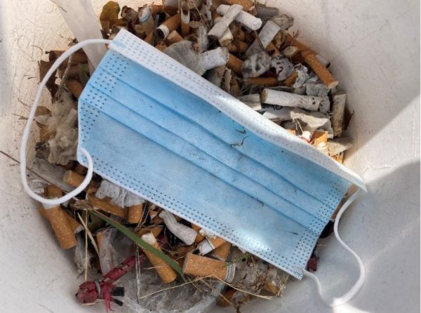 A bucket full of butts and a disposable face mask from an Olympia chapter Downtown Butt Pickup