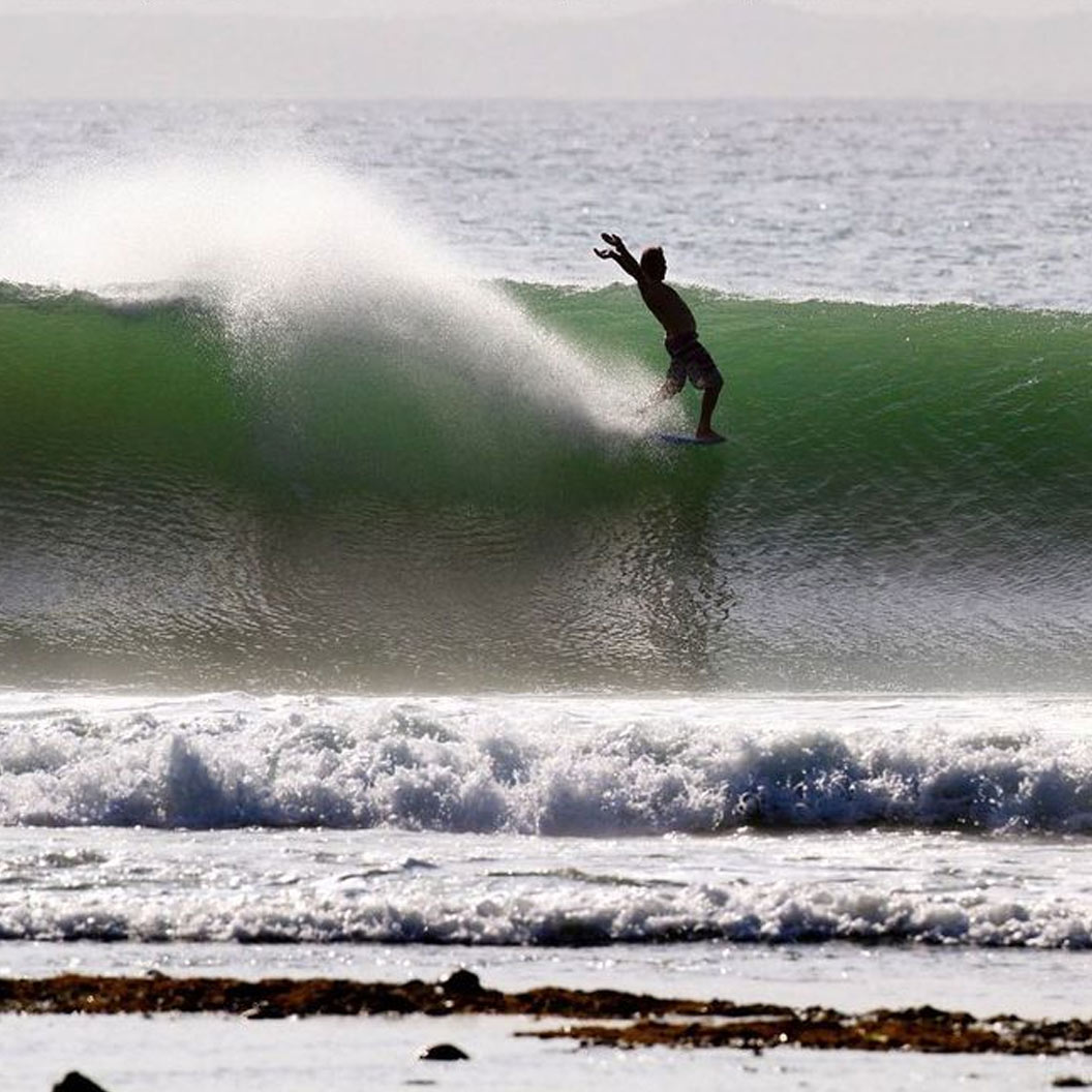 Charlie Quesnel riding a wave