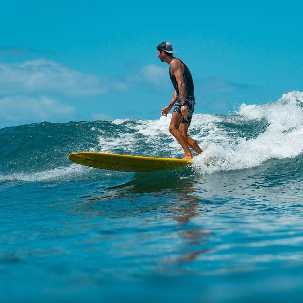 Enzo Magliozzi riding a longboard in Maui