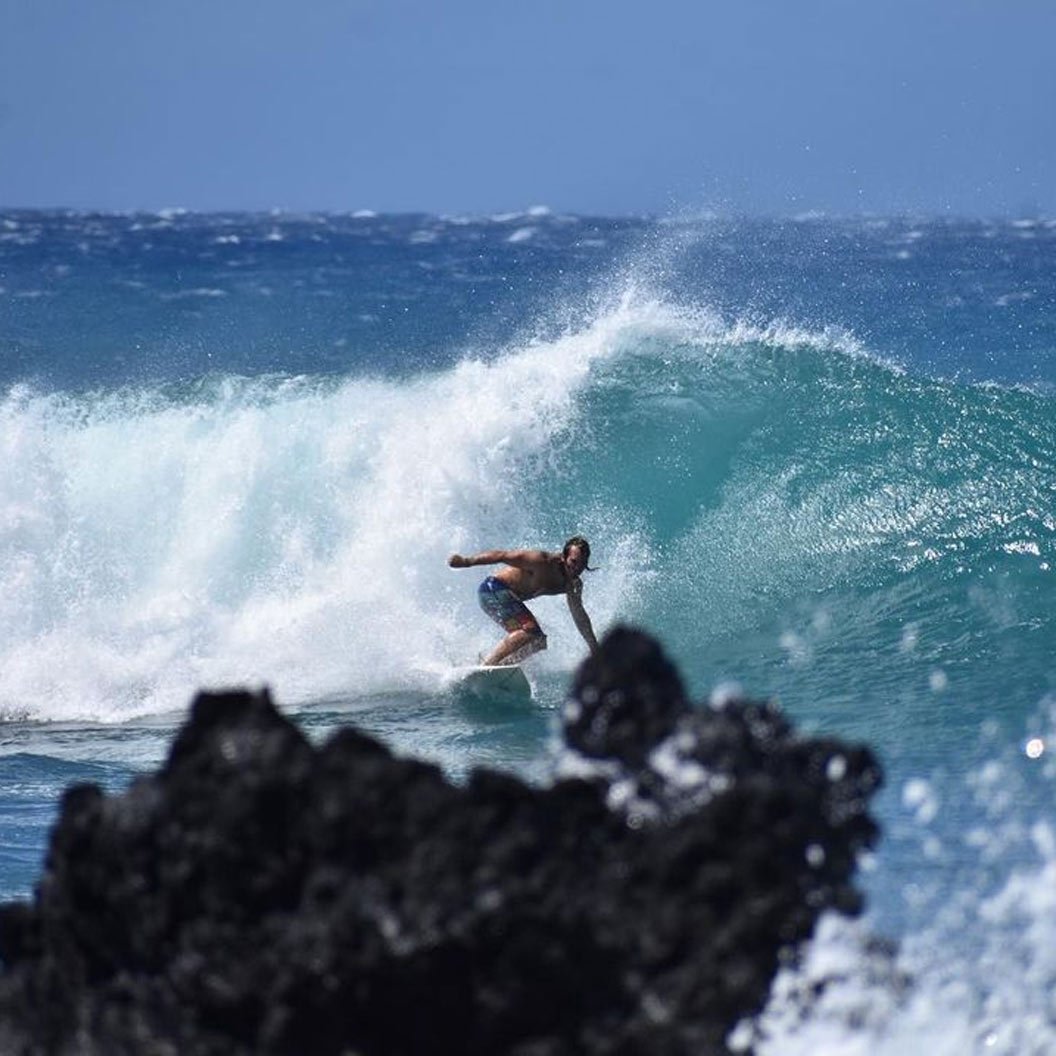 Greg Masessa catching a wave in Maui