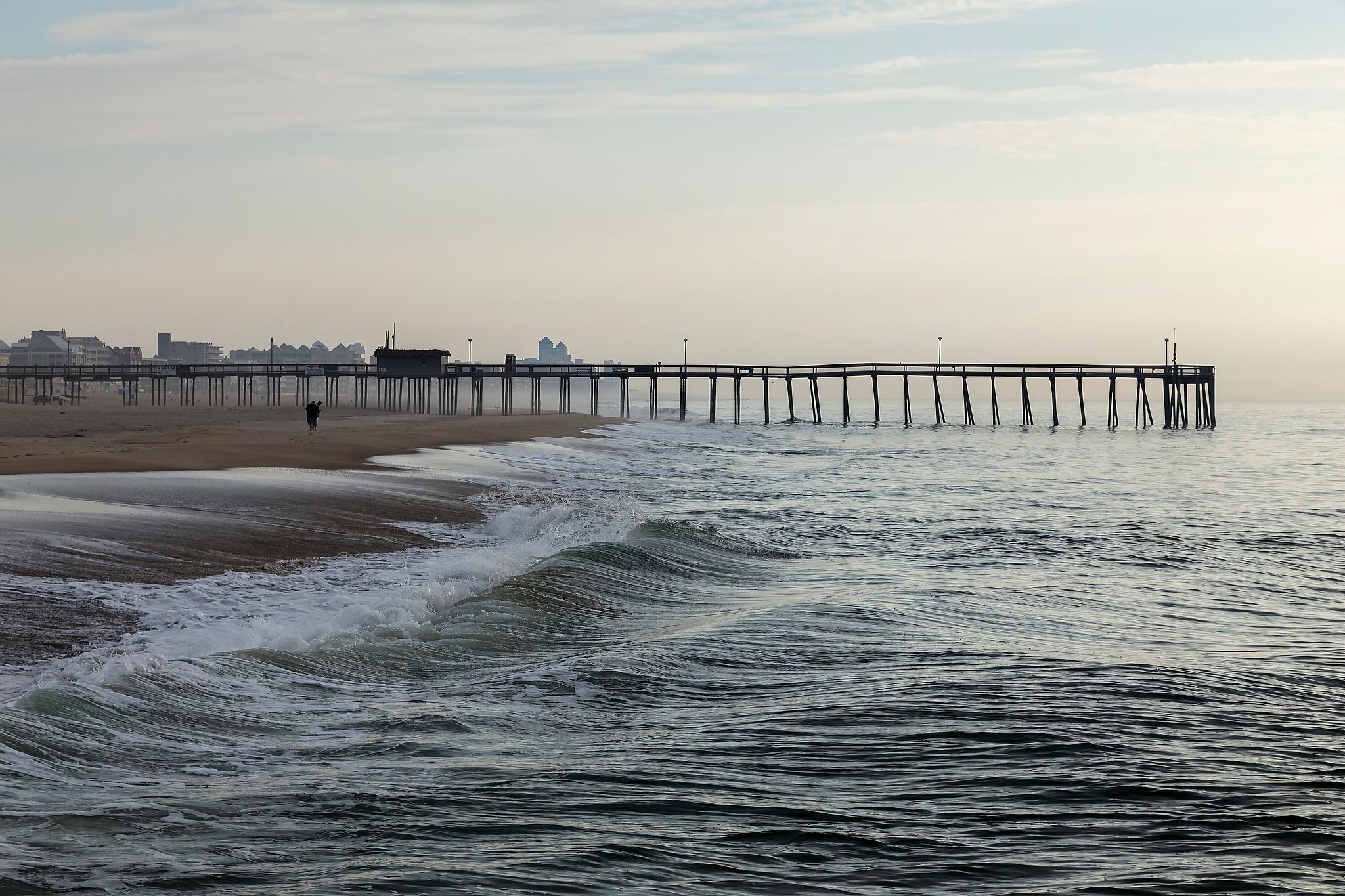 Ocean City fishing pier with waves in the foreground