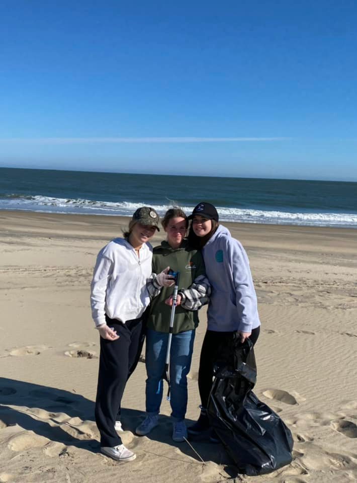 Group of girls cleaning up the beach