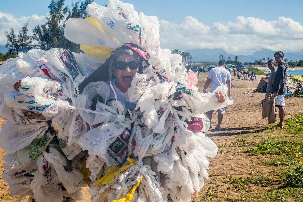 volunteer covered in trash at beach cleanup