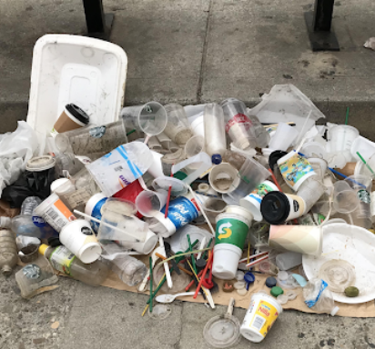 Used single used plastics piled up on the sidewalk