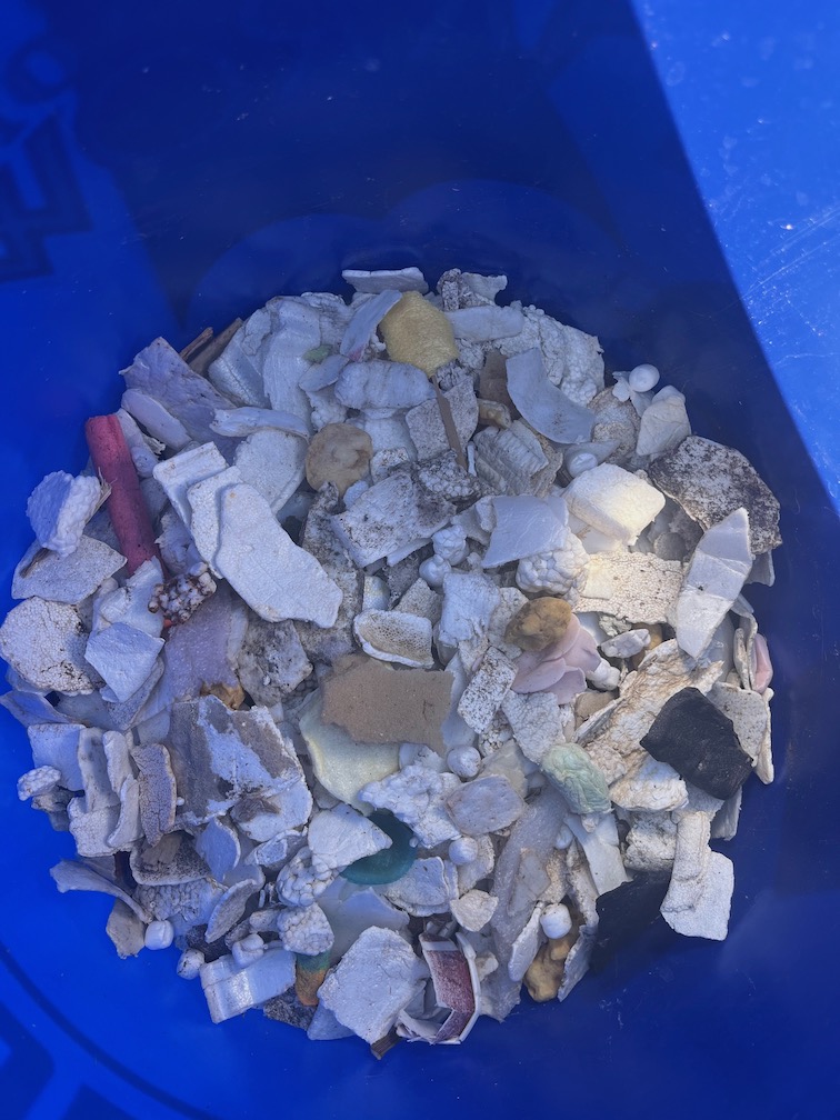 A bucket full of foam pieces from a beach in Oceanside